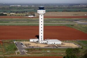 An aerial view of a control tower in the middle of nowhere.