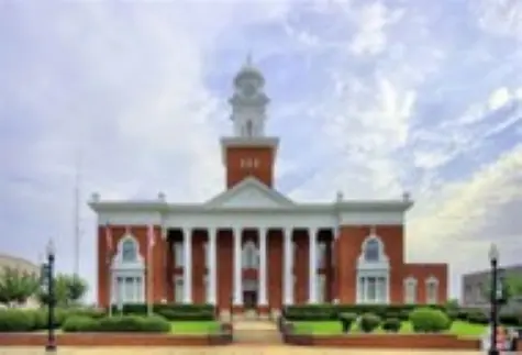 A historic brick courthouse with a clock tower.