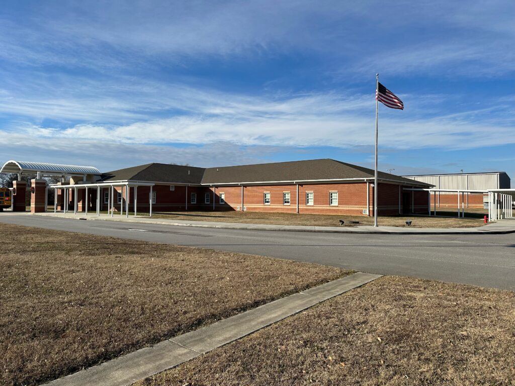 Brick school building with American flag.