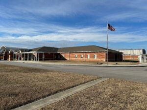 Brick school building with American flag.