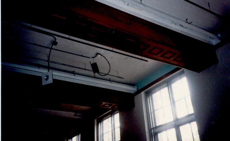 Interior shot of a building ceiling with windows.