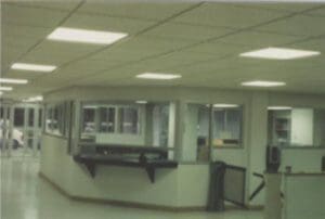 Empty office with windows and a desk.