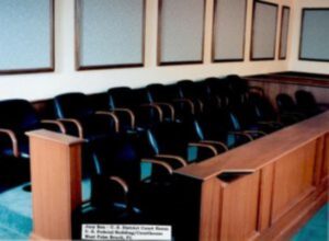 Courtroom with wooden jury box and chairs.