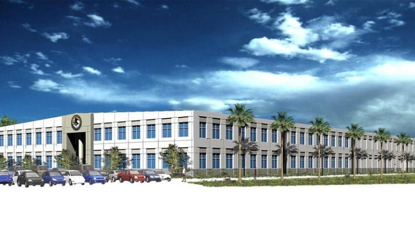 A modern office building with palm trees.