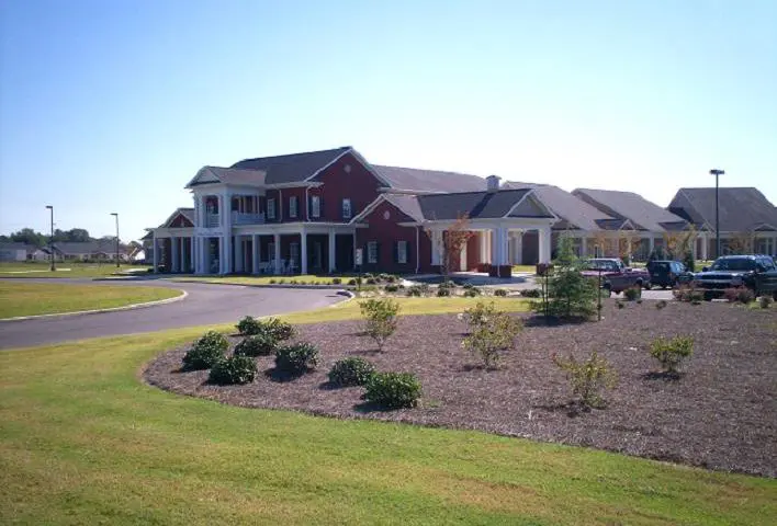 A large red brick building with a white trim.