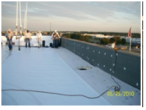 Workers installing a white roof membrane.