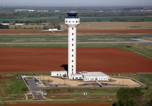 An aerial view of a control tower in the middle of nowhere.
